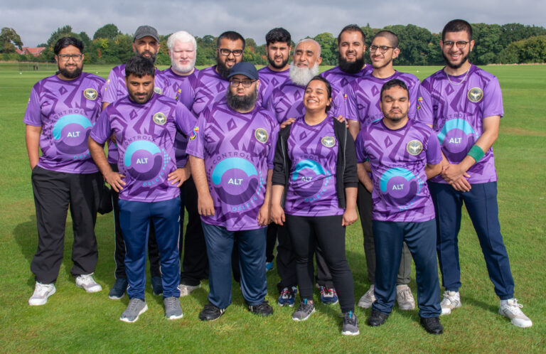 Falcons team members together in purple kit before a cricket match.